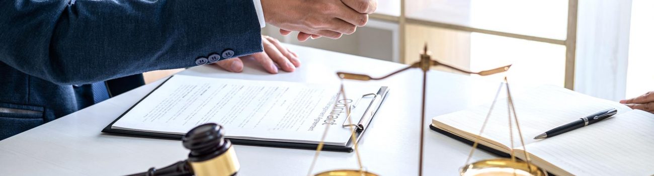 Handshake after good cooperation, Businesswoman Shaking hands with Professional male lawyer after discussing good deal of contract in courtroom, Concepts of law, Judge gavel with scales of justice.